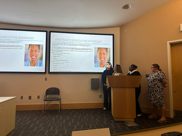 Group of students from the grant writing course during their presentation.