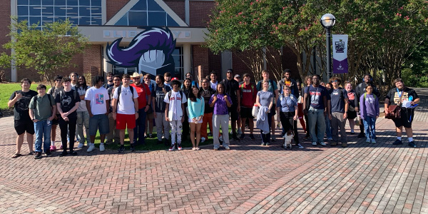 A large group of IT students posing for a group photo outside of MGA's Macon campus library.