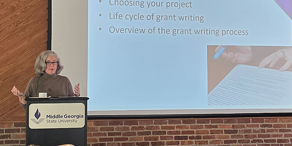 Dr. Monica Miller giving a presentation during the CMGS/ORSP event.