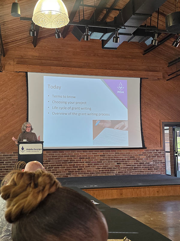 Dr. Monica Miller giving a presentation during the CMGS/ORSP event.