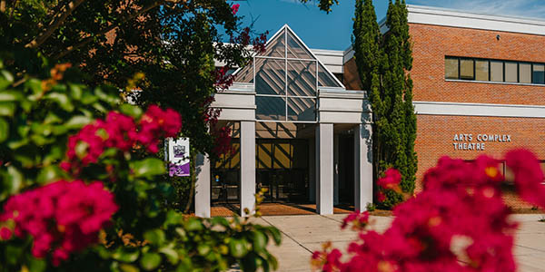 Front of the MGA SOAL building lined with pink crepe myrtle trees.