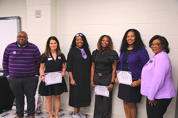 Group of award recipients posing for a photo at the ceremony.
