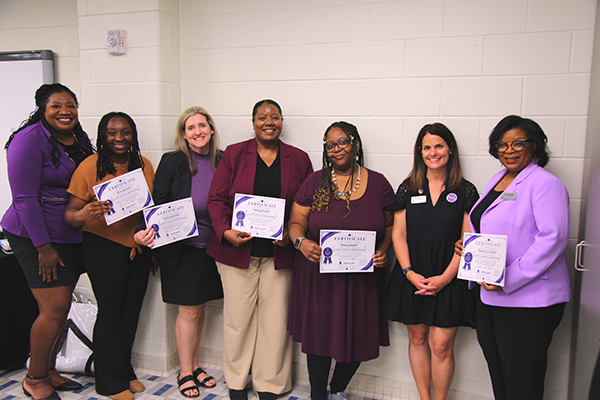 Group of award recipients posing for a photo at the ceremony.